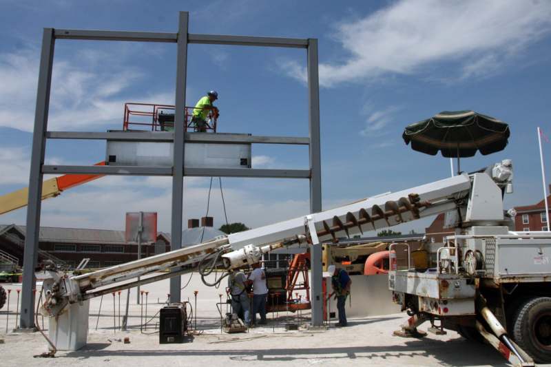 a group of people working on a metal structure