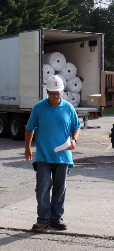 a man wearing a hard hat and a blue shirt