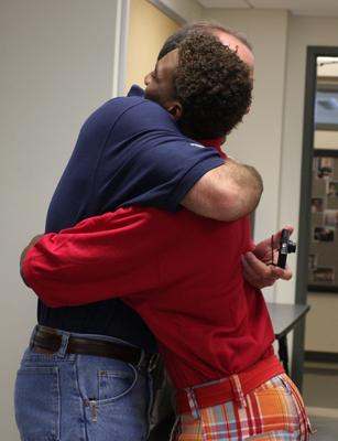 a couple of men hugging