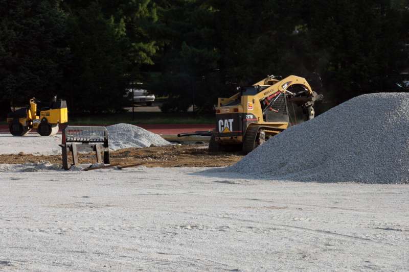 a construction site with a bulldozer and gravel