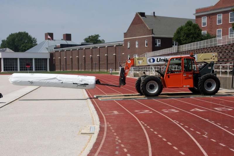 a forklift loading a large object on a track