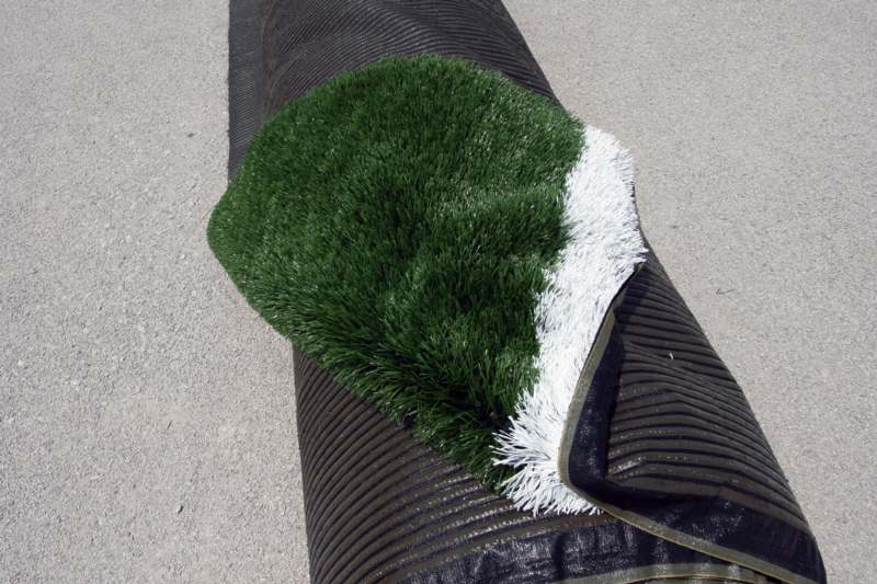 a green and white carpet on a black roll