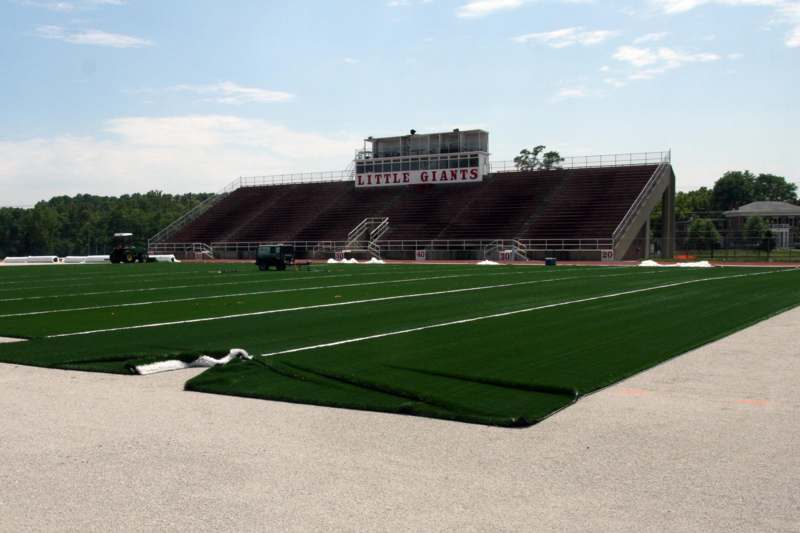 a football field with a stadium and bleachers