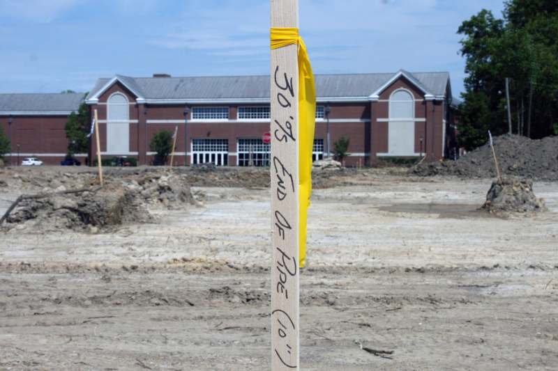 a wooden post with yellow tape on it
