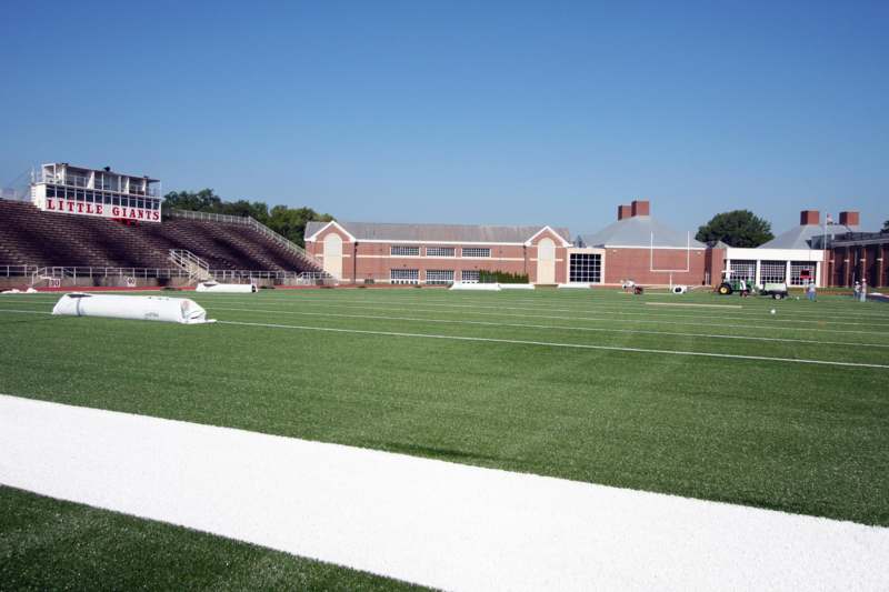 a football field with a building and a tower