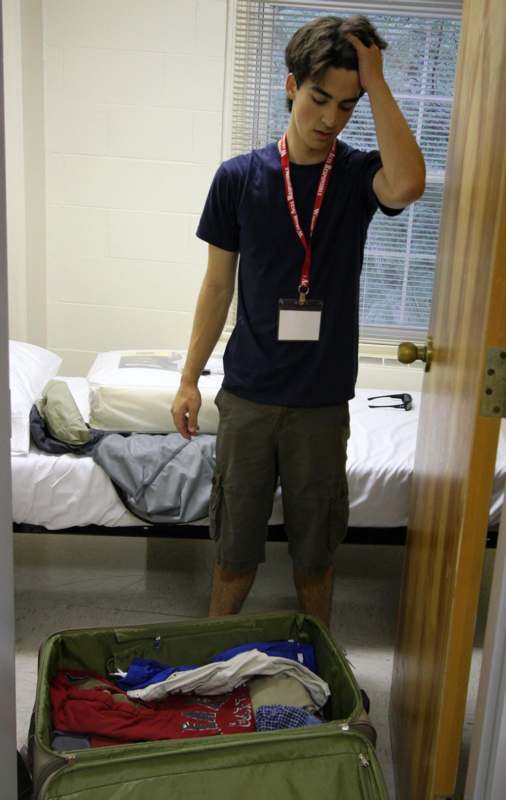 a man standing in a room with luggage