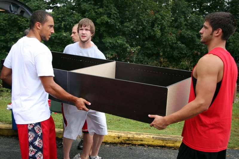 a group of men carrying a box