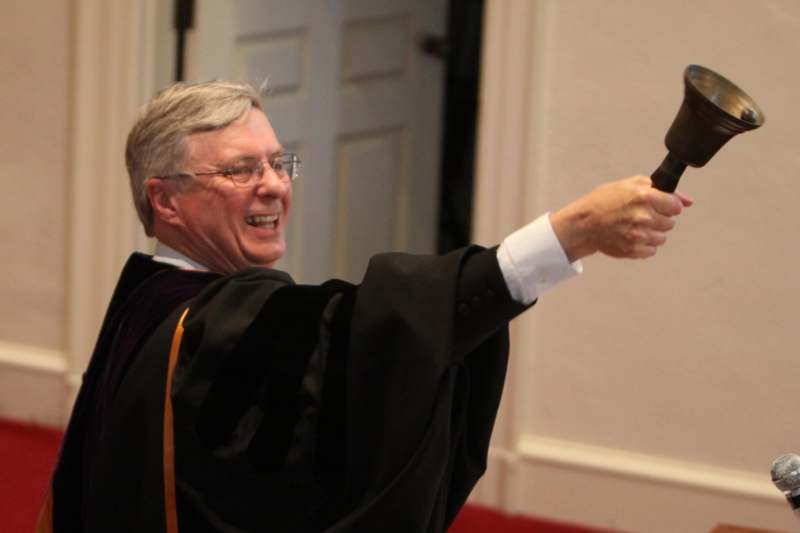 a man in a robe pointing a gun