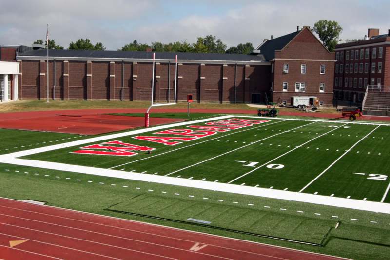 a football field with a brick building