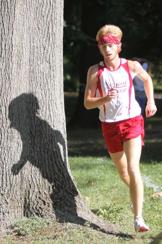 a man running next to a tree