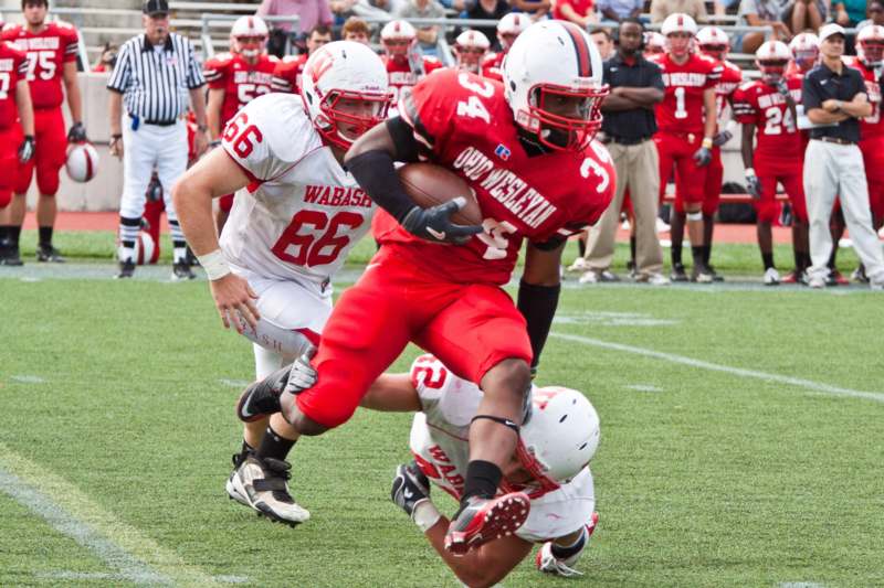 a football player in red and white uniform running with a football
