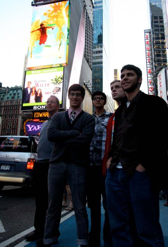 a group of men standing in a city street