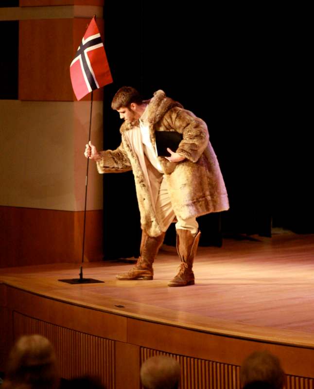 a man in a fur coat holding a flag