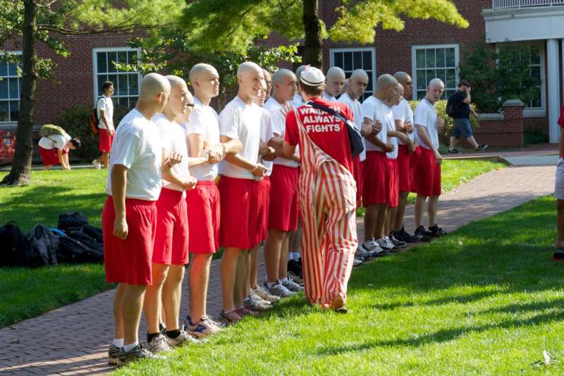 a group of men in red shorts standing in a line