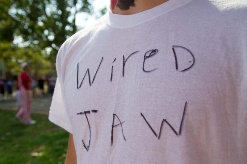 a person wearing a white shirt with writing on it