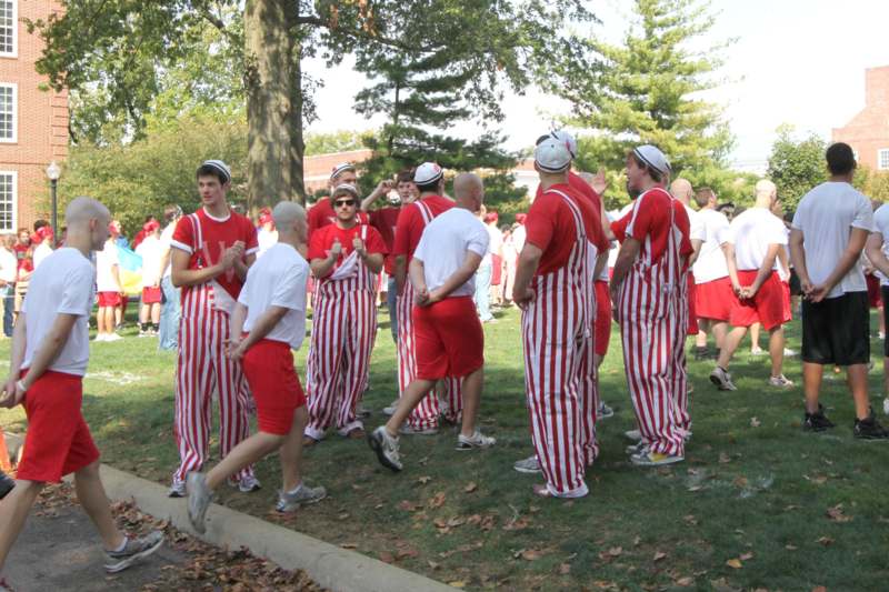 a group of people in striped red and white outfits