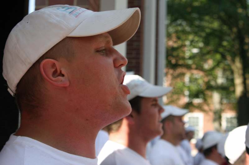 a group of men wearing white shirts and hats