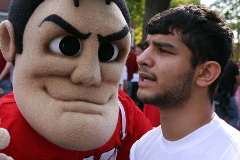 a man looking at a person in a mascot garment
