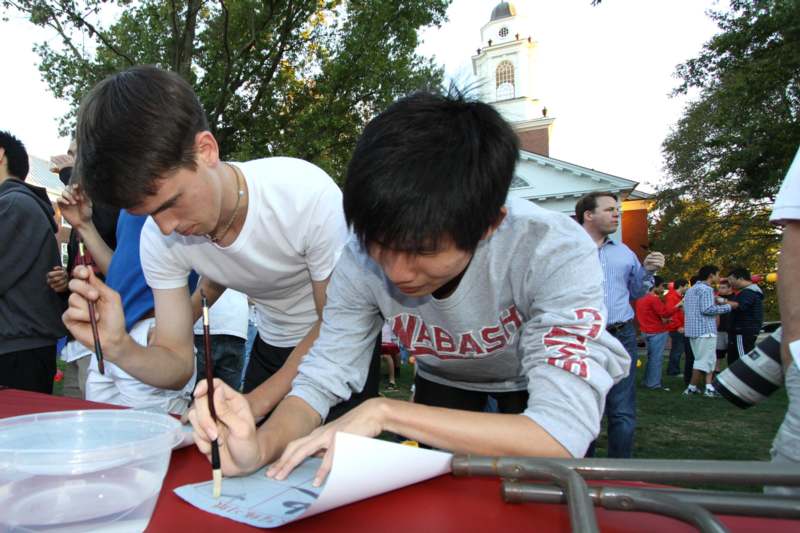 a group of young men writing on a paper