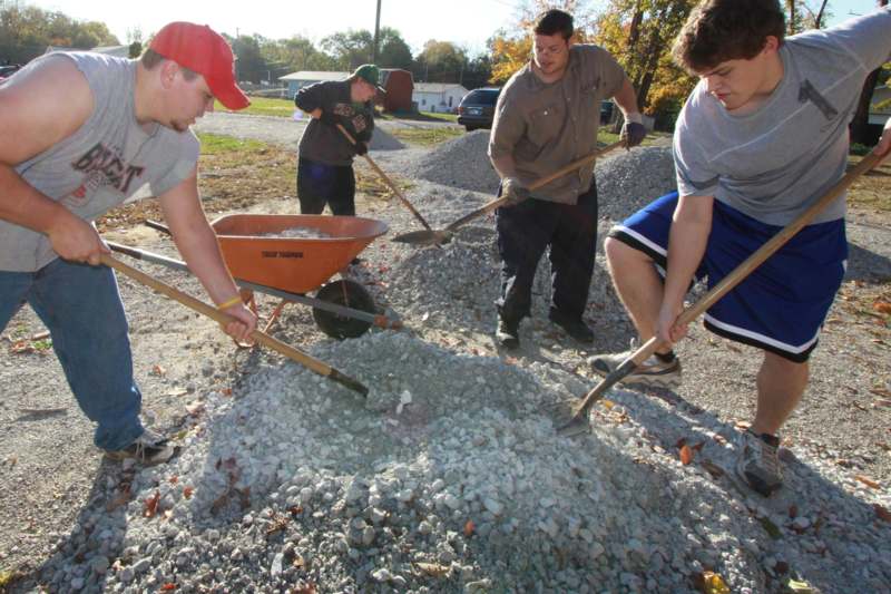 a group of men digging in gravel