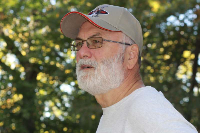 a man with a white beard and a baseball cap