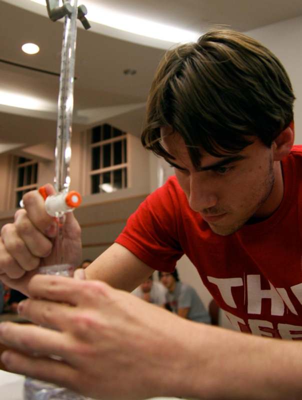 a man holding a pipette