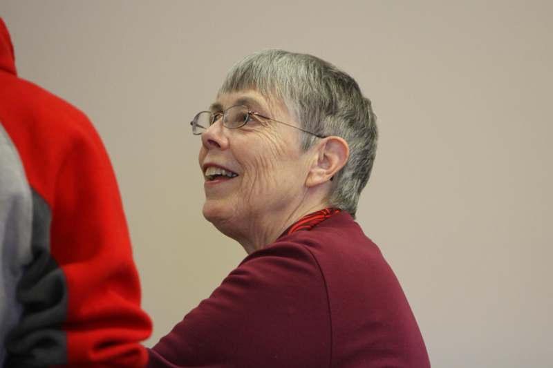a woman in glasses smiling