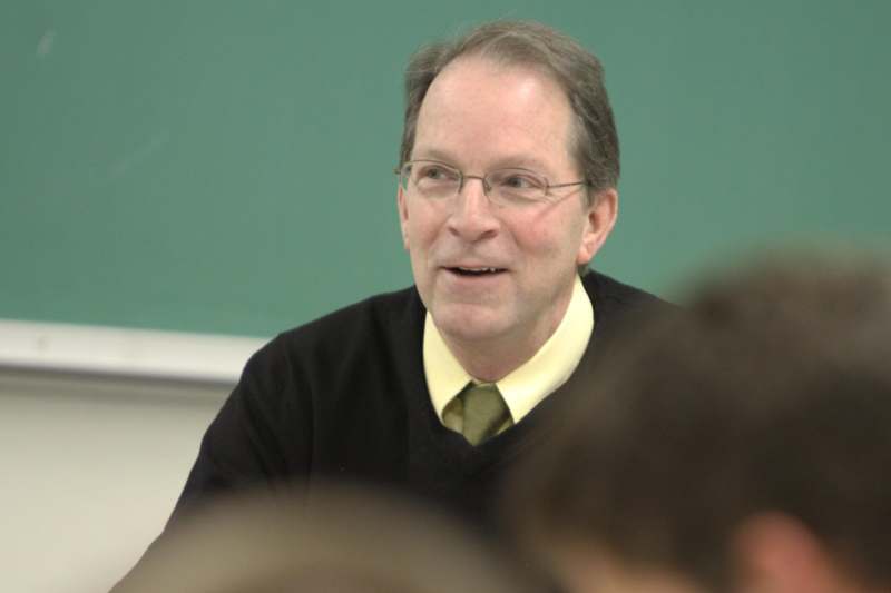 a man in a black sweater and glasses