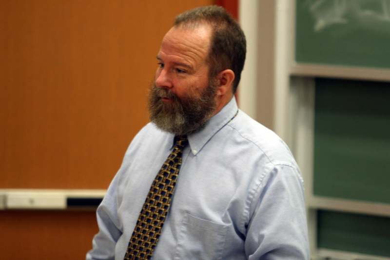 a man with a beard wearing a tie