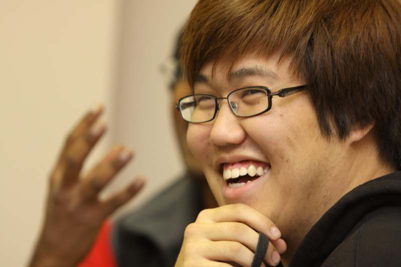 a man wearing glasses laughing