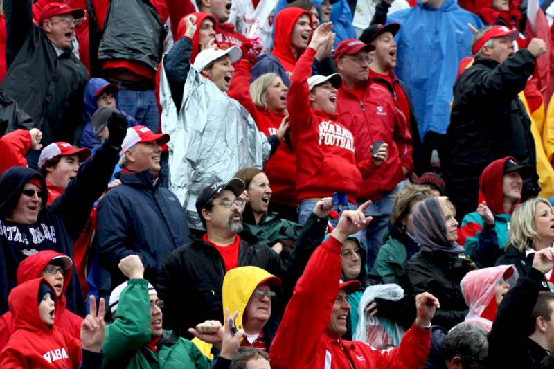 a group of people in red jackets cheering