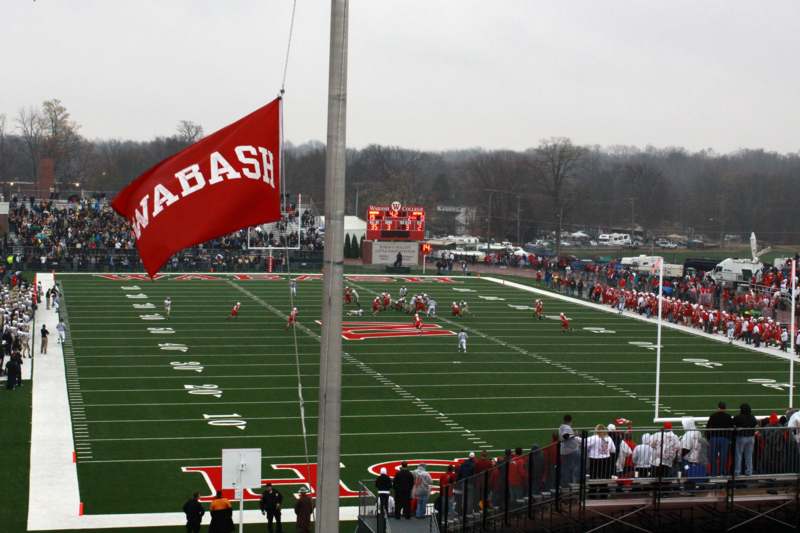 a football field with a flag and people watching