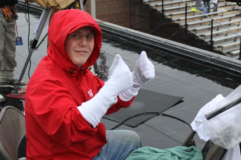 a man wearing a red jacket and white gloves