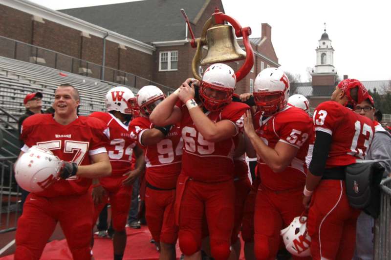 a football players carrying a bell