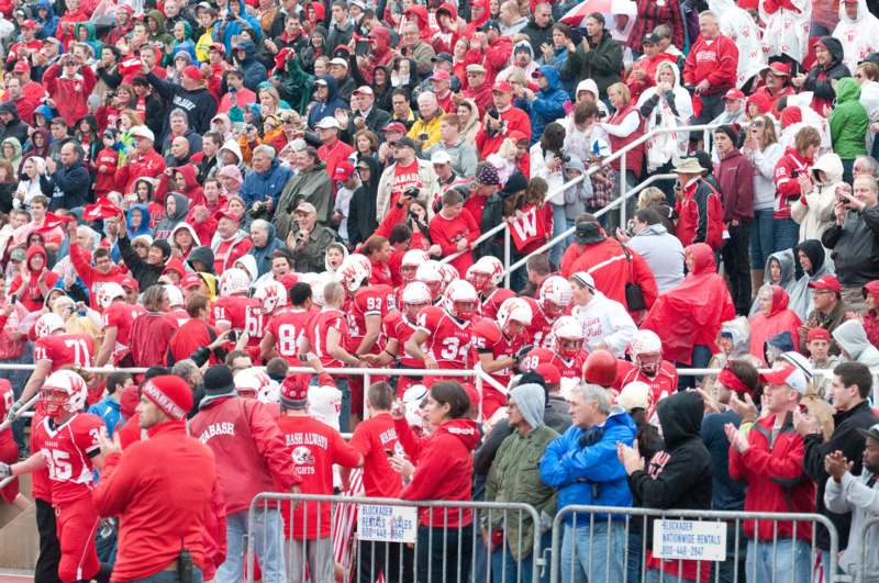 a crowd of people in red shirts