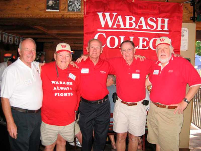 a group of men in red shirts