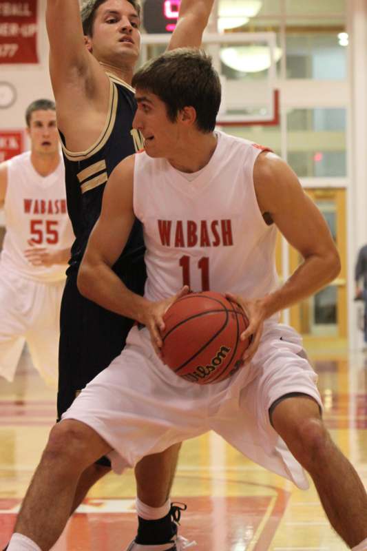 a man in a basketball uniform with a basketball in his hand