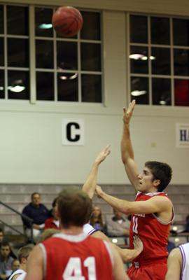 a basketball player reaching for a shot