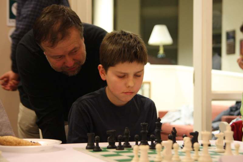 a man and boy playing chess