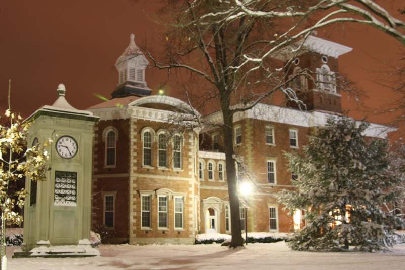 a building with a clock in the snow