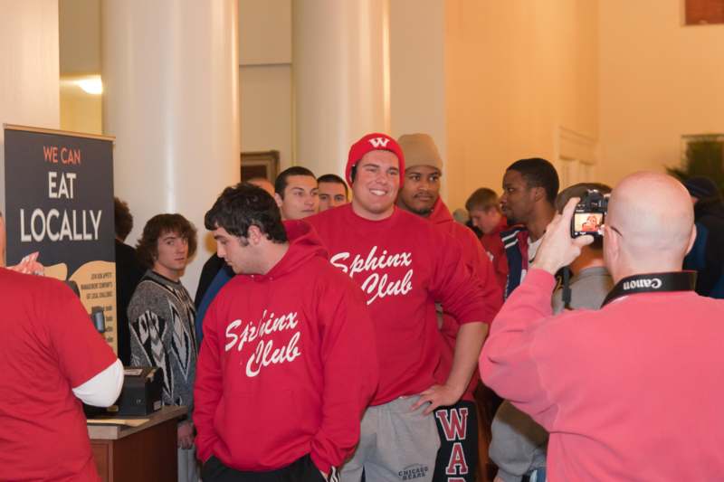 a group of people in red sweatshirts