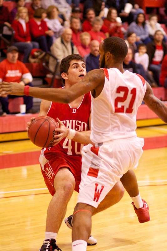 a basketball player in red uniform dribbling a ball