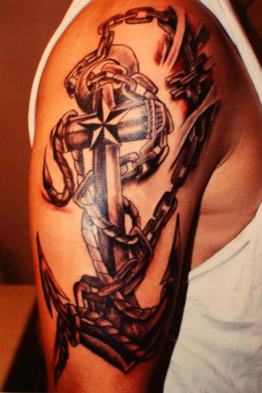 a tattoo of a cross and chain
