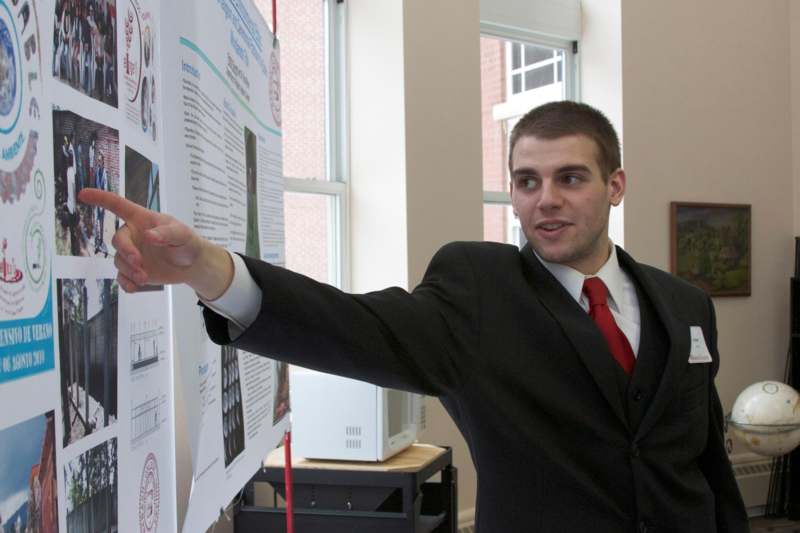 a man pointing at a poster