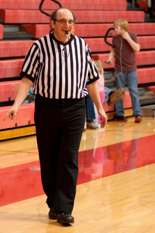 an old man in a referee's uniform