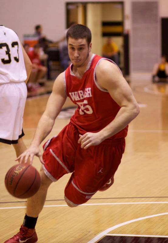 a man in a basketball uniform dribbling a basketball