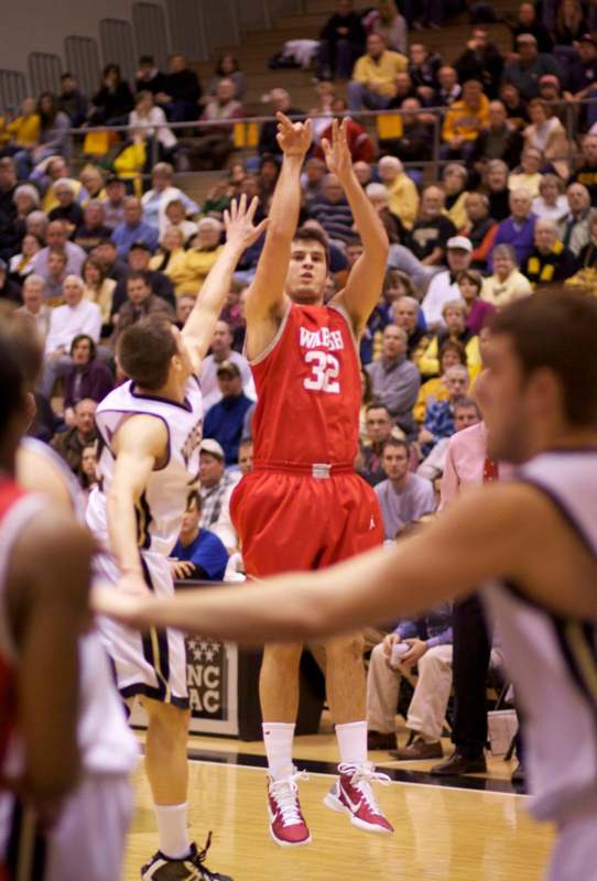 a basketball player shooting a ball