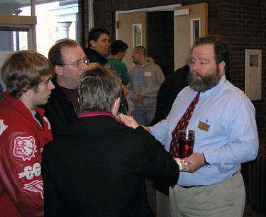 a man holding a drink and a man holding a glass
