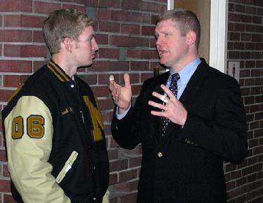 a man talking to another man