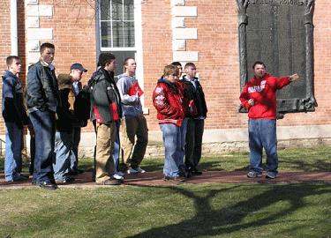 a group of people standing on grass